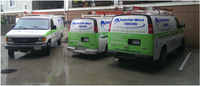 Three service vans parked in a lot, including Superior West Electric vehicles in Burnaby
