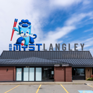 MYST Langley restaurant exterior with blue mascot character holding skis on rooftop sign in Burnaby