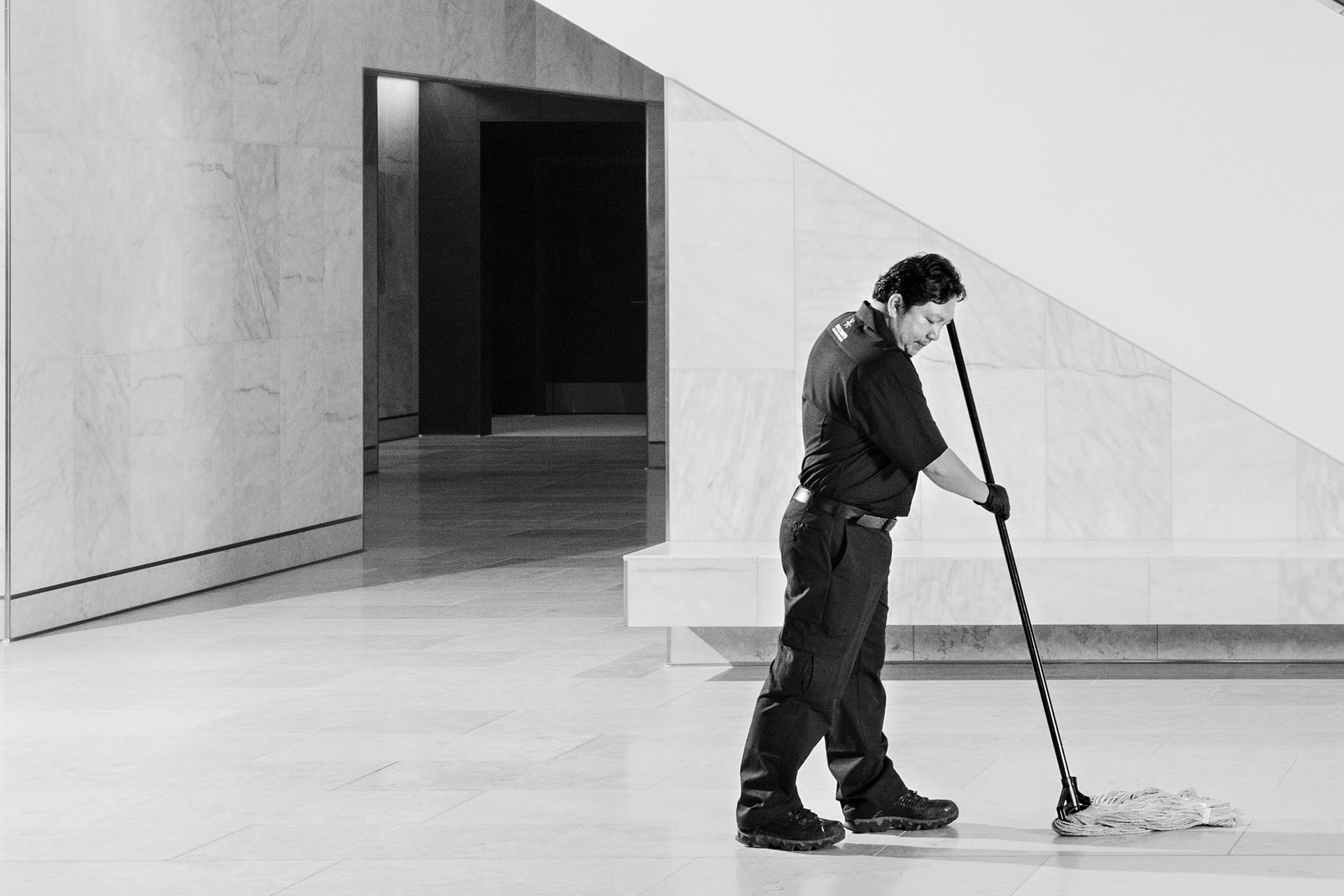 Janitor mopping floor in modern commercial building in Burnaby