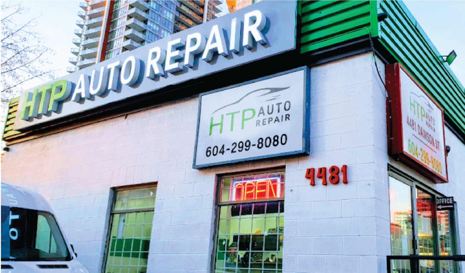 HTP Auto Repair storefront in Burnaby with signage displaying phone number 604-299-8080 and address 4481, featuring green window frames and an open sign