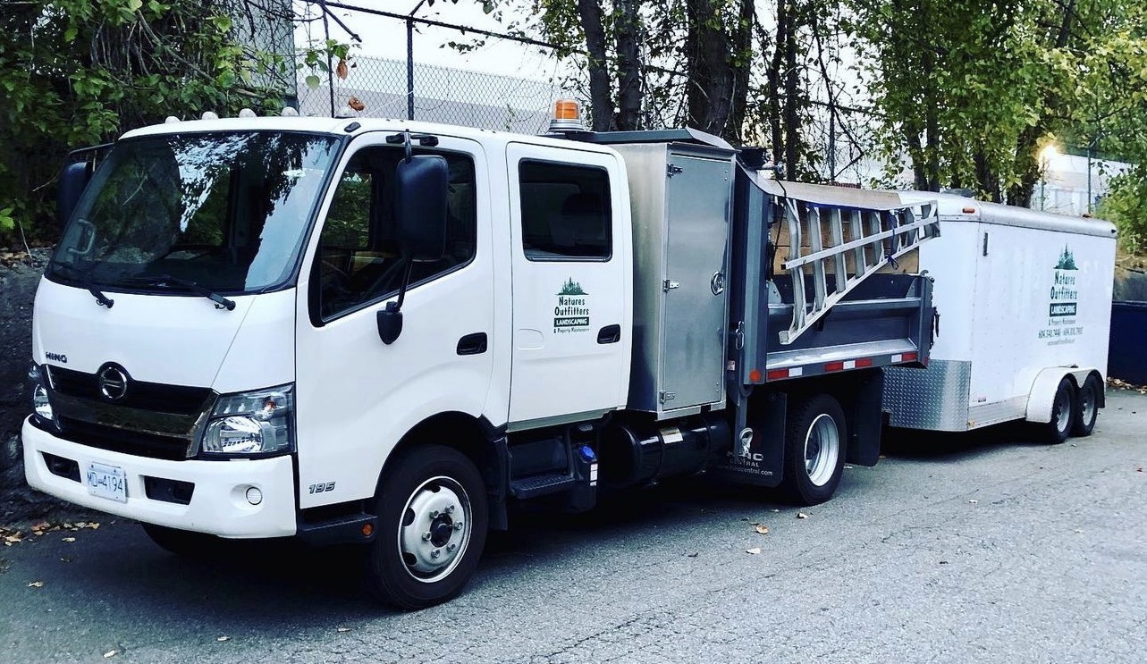 White Hino truck with attached landscaping trailer parked at Nature's Outfitters in Burnaby Nature's Outfitters Landscaping T