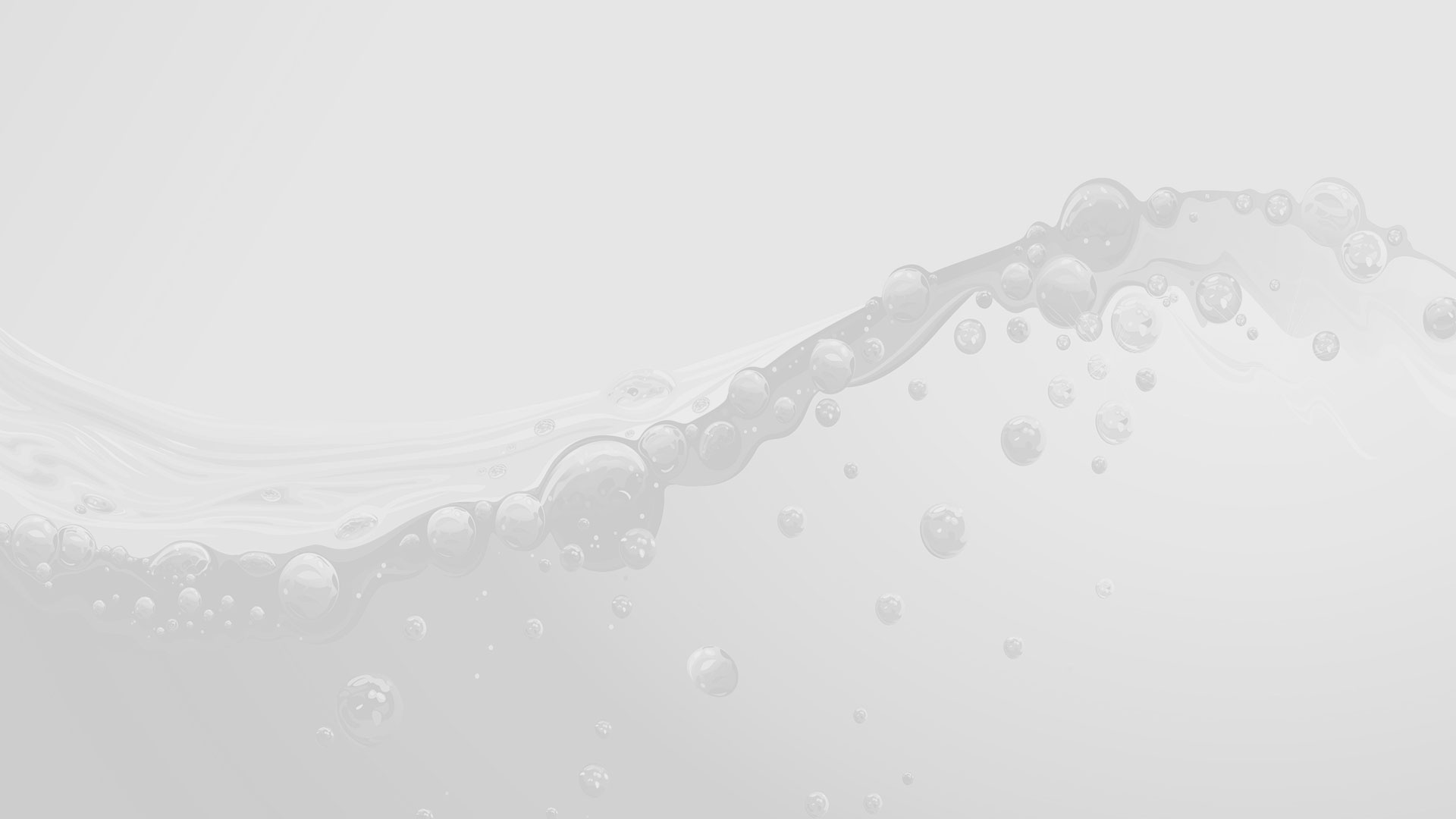 Close-up of water bubbles and droplets flowing across a light gray surface, representing professional cleaning and pressure washing services