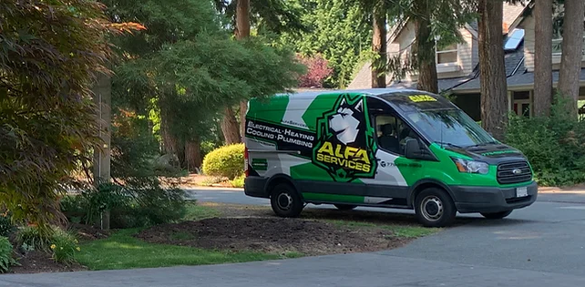 Green and white Alfa Services utility van parked on a residential street in Burnaby with large trees in the background