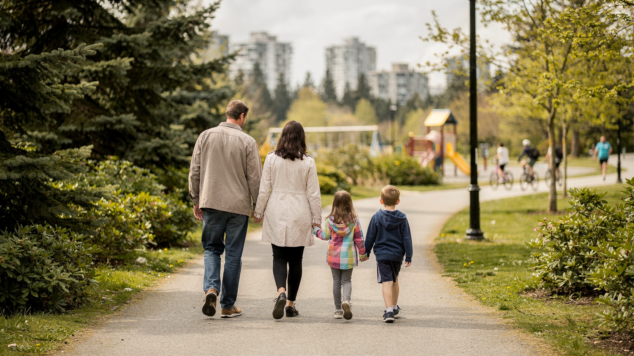 burnaby bc parks family outings v2 Parks In Burnaby for family outings Family walking away down a tree lined park path toward a playground in Burnaby, BC