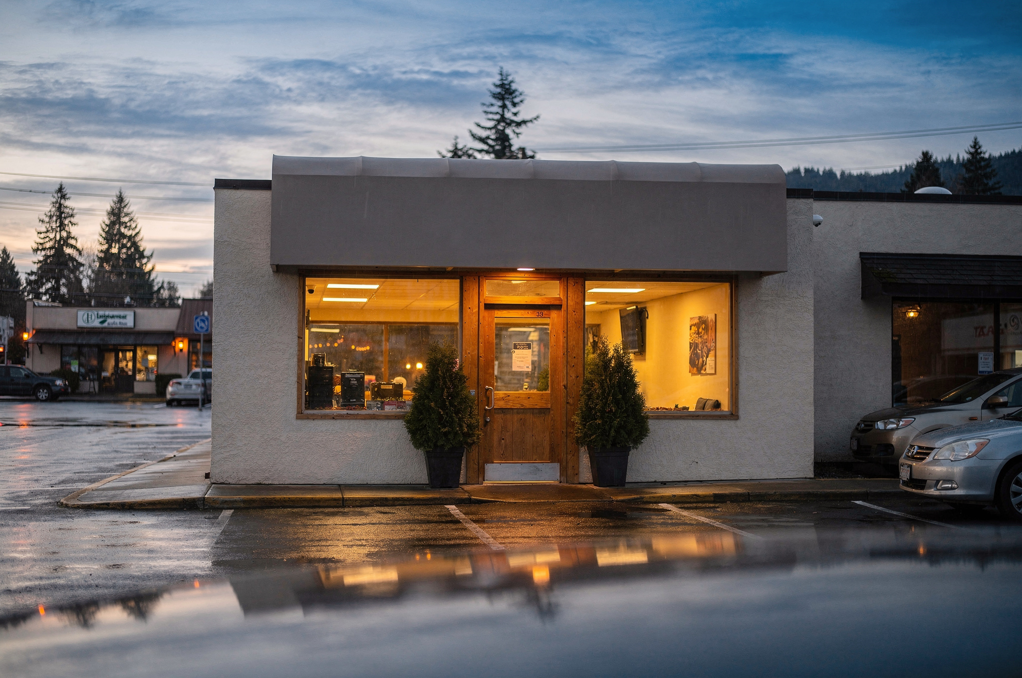 Small restaurant storefront in a Burnaby strip mall at dusk