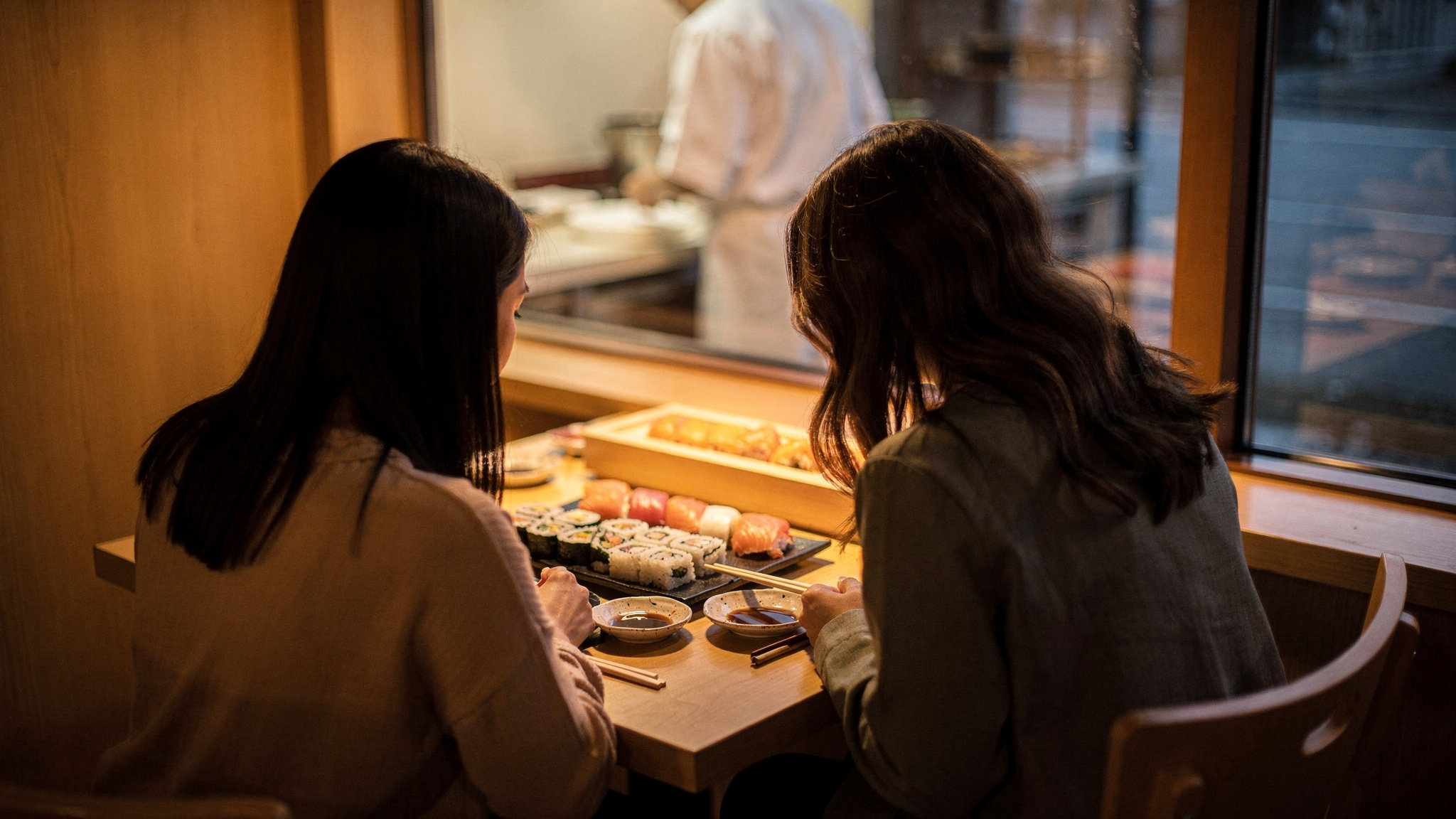 sushi in burnaby v2 Sushi in Burnaby Two diners eating sushi from behind at a Burnaby sushi restaurant